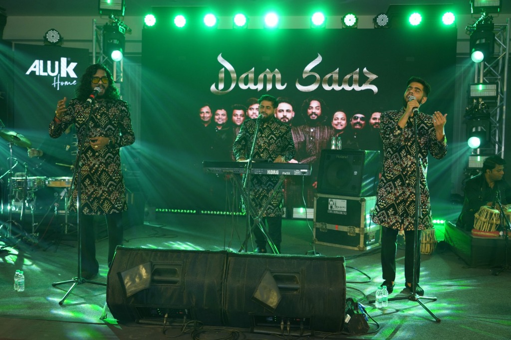 Dam Saaz performers singing live at AluK corporate event with green stage production